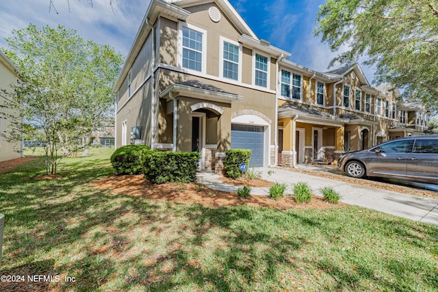 multi unit property featuring a front yard and a garage