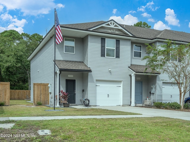 view of front of house featuring a front yard and a garage