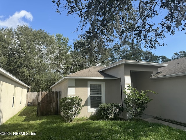 view of property exterior with a yard