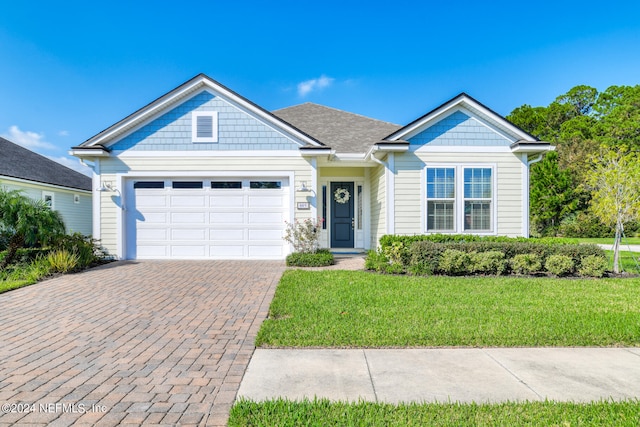 view of front of house with a front lawn and a garage