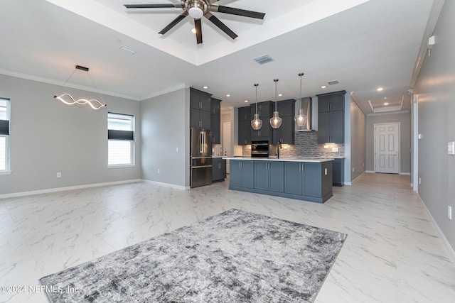 kitchen with backsplash, wall chimney range hood, decorative light fixtures, an island with sink, and high end fridge