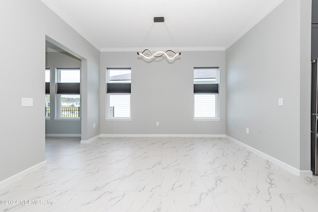 empty room featuring plenty of natural light and crown molding