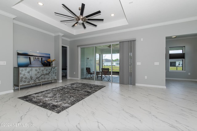 living room with ornamental molding, ceiling fan, and a tray ceiling