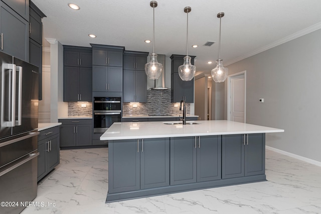 kitchen with decorative light fixtures, wall chimney range hood, stainless steel appliances, and a spacious island