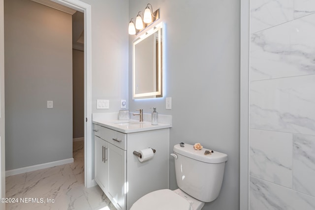 bathroom featuring toilet and vanity