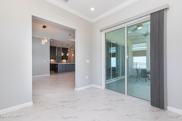 spare room featuring ceiling fan and crown molding