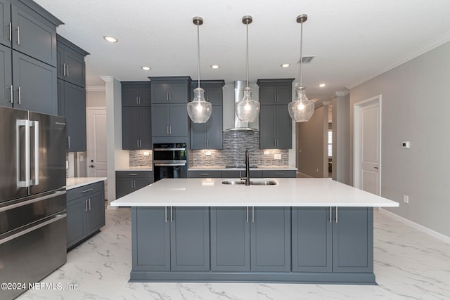 kitchen with pendant lighting, wall chimney exhaust hood, a center island with sink, and high end refrigerator