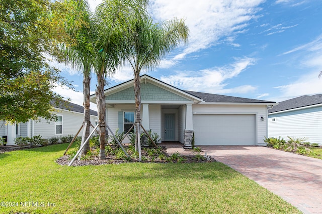 view of front of property featuring a garage and a front yard