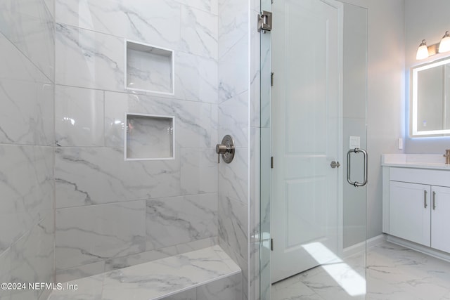 bathroom featuring vanity and a shower with shower door