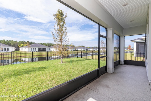 unfurnished sunroom with a water view