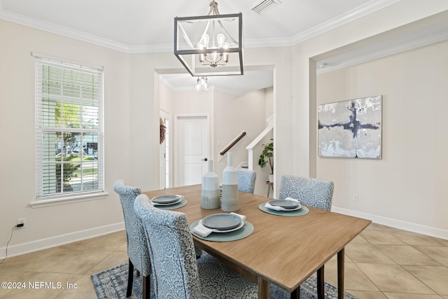 dining space with light tile patterned floors, crown molding, and a notable chandelier