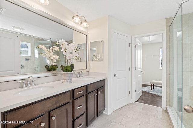 bathroom with tile patterned floors, vanity, and walk in shower