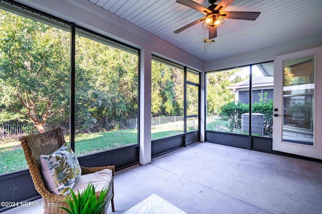 unfurnished sunroom with ceiling fan and plenty of natural light