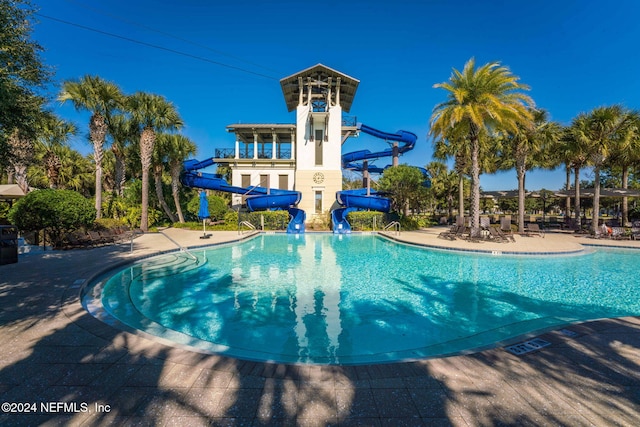 view of swimming pool featuring a patio area and a water slide