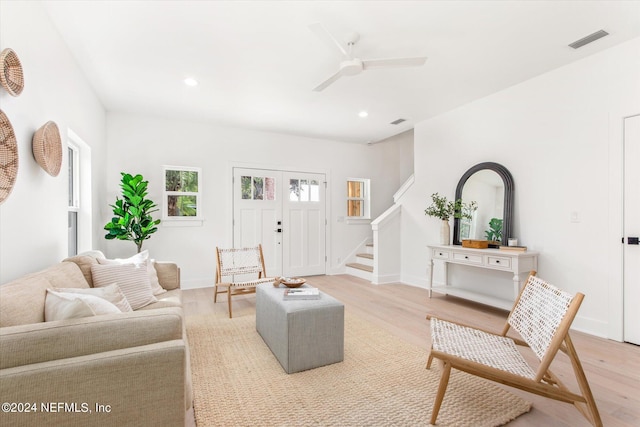 living room with ceiling fan and light hardwood / wood-style flooring