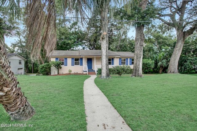 single story home with a garage and a front lawn