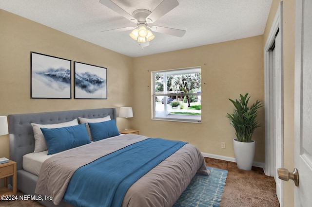 carpeted bedroom featuring a closet, ceiling fan, and a textured ceiling