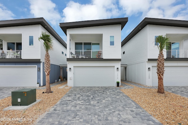 contemporary house with a balcony and a garage