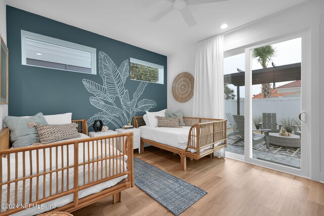 bedroom featuring light hardwood / wood-style flooring, ceiling fan, and access to exterior