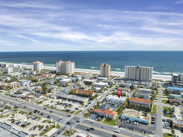 aerial view with a water view and a view of the beach