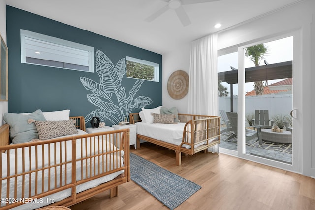 bedroom with light wood-type flooring, ceiling fan, and access to outside