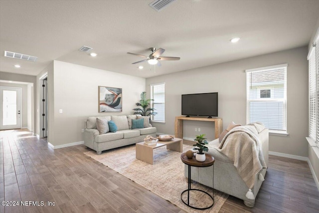 living room featuring ceiling fan and wood-type flooring