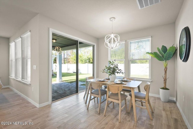 dining room with a notable chandelier and light hardwood / wood-style flooring