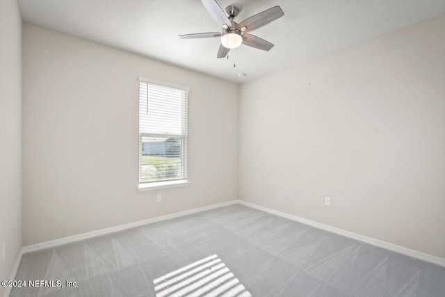 unfurnished room featuring light carpet and ceiling fan