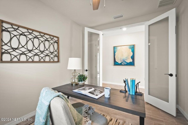 office with french doors, ceiling fan, and hardwood / wood-style floors