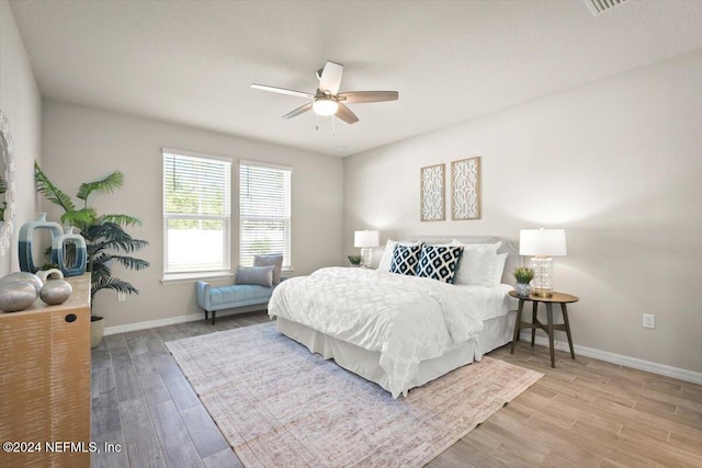 bedroom with light hardwood / wood-style floors and ceiling fan