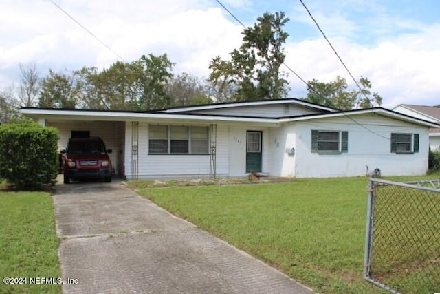 ranch-style home featuring a carport and a front yard