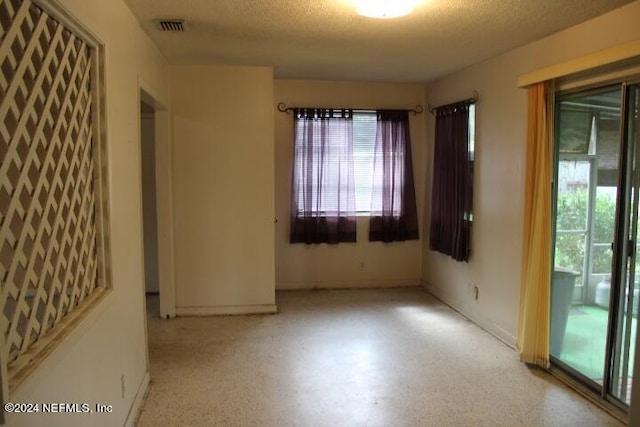 empty room with a textured ceiling