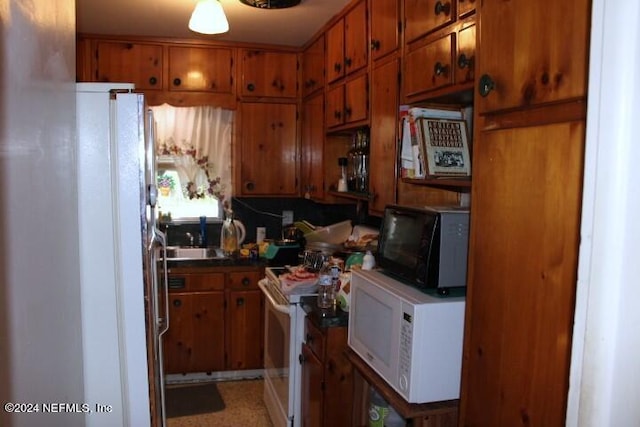 kitchen featuring sink and white appliances