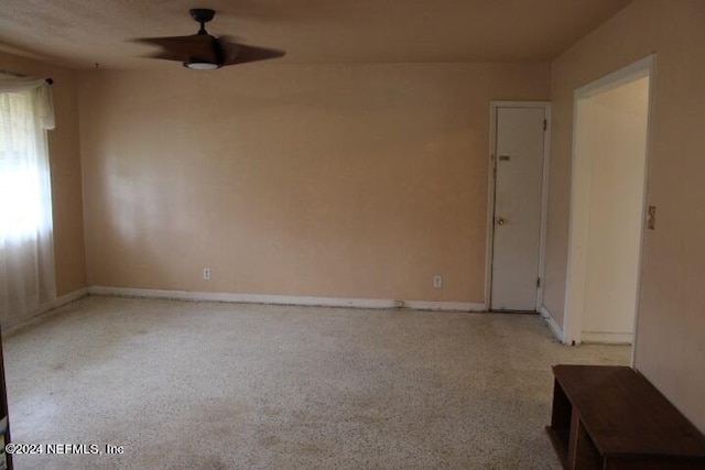 spare room featuring ceiling fan and light carpet