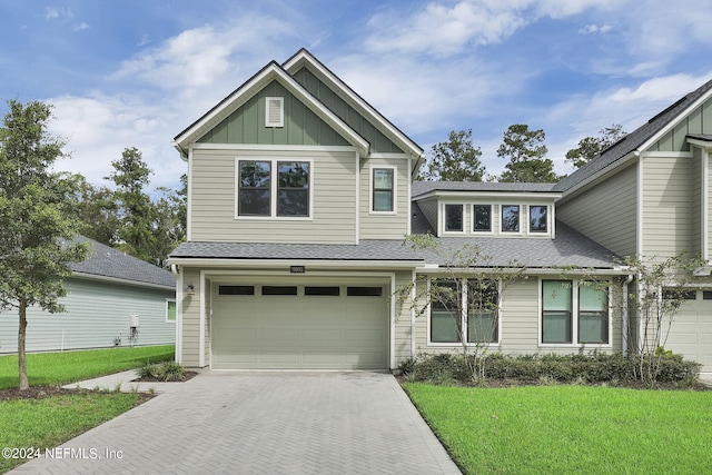 view of front of home featuring a front yard and a garage