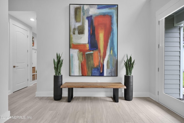 hallway with light hardwood / wood-style flooring