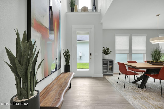 foyer entrance with wine cooler and light wood-type flooring