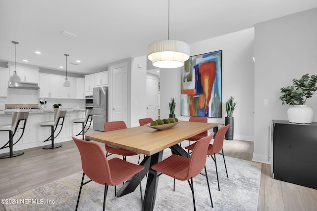 dining space with light wood-type flooring