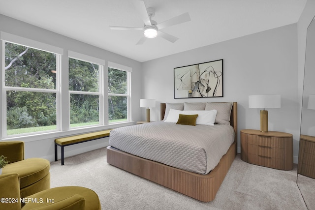 bedroom with light carpet and ceiling fan