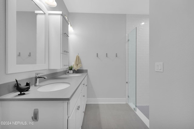 bathroom featuring a shower with door and vanity