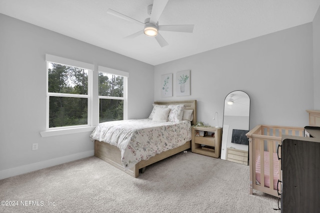 bedroom featuring ceiling fan and light colored carpet