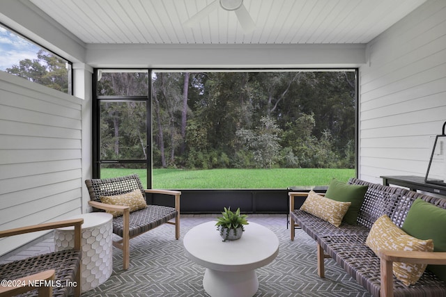 sunroom / solarium featuring ceiling fan