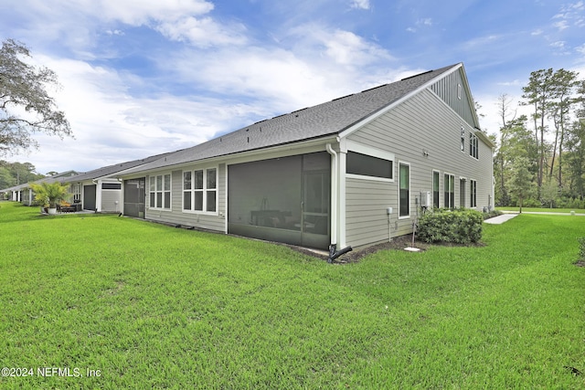 exterior space featuring a sunroom and a yard