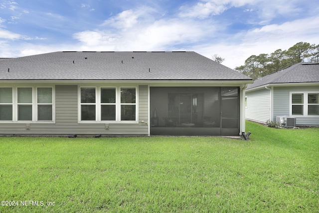 back of house featuring a yard, a sunroom, and central AC unit