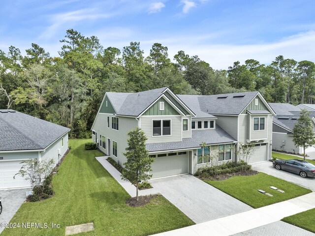 view of front of house featuring a garage and a front yard