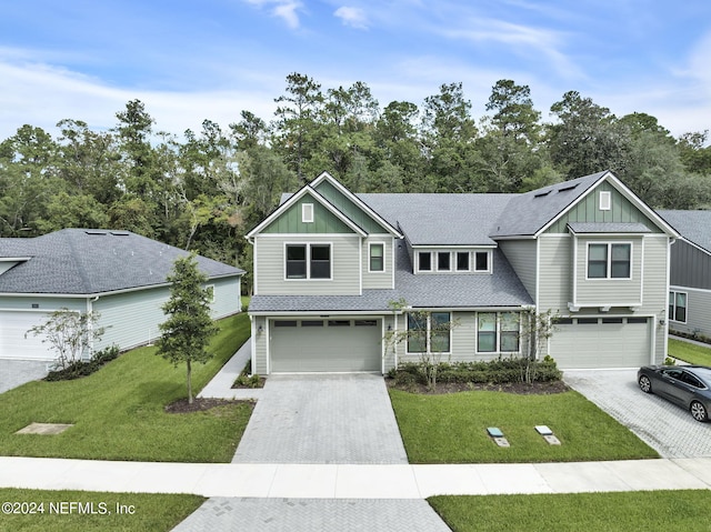 view of front of home featuring a garage and a front lawn