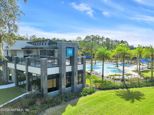 exterior space with a swimming pool and a yard