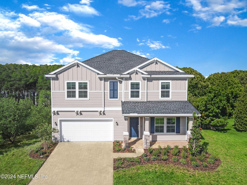 view of front of home featuring a garage and a front yard