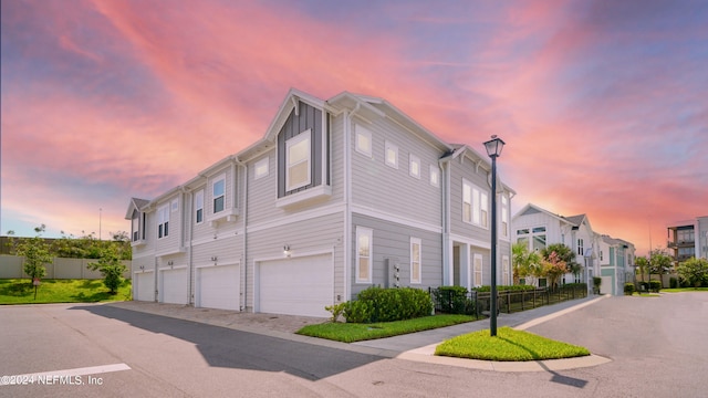 property exterior at dusk featuring a garage