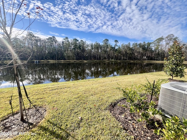 view of yard featuring cooling unit and a water view